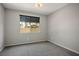 Bedroom with soft carpet and a window that looks out onto a house at 3484 Bradano Ln, Henderson, NV 89044