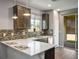 Modern kitchen with stainless steel appliances and breakfast bar at 3484 Bradano Ln, Henderson, NV 89044