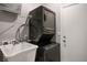 A laundry room with a stacked washer and dryer and a utility sink at 3484 Bradano Ln, Henderson, NV 89044