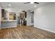 Bright living room with hardwood floors adjacent to a kitchen area at 3484 Bradano Ln, Henderson, NV 89044