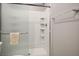 Shower featuring glass doors, built-in shelves, and updated fixtures at 3484 Bradano Ln, Henderson, NV 89044