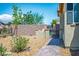 Landscaped side yard with brick paver walkway and privacy wall at 3484 Bradano Ln, Henderson, NV 89044