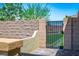 Landscaped side yard featuring an iron gate and privacy wall at 3484 Bradano Ln, Henderson, NV 89044