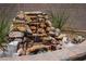 Close up of the outdoor rock waterfall feature in the backyard at 3484 Bradano Ln, Henderson, NV 89044