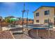 Backyard featuring a trampoline, outdoor dining set, and gravel landscaping at 3592 Gloucester Gate St, Las Vegas, NV 89122