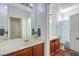 Well-lit bathroom with a double sink vanity, large mirror, and a separate toilet and shower area at 3592 Gloucester Gate St, Las Vegas, NV 89122