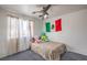 Cozy bedroom featuring a ceiling fan, plush carpet, and a large window for natural light at 3592 Gloucester Gate St, Las Vegas, NV 89122