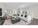 Staged living room featuring a white sofa, area rug, and modern decor at 367 Wilford Springs St, Henderson, NV 89014