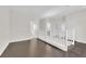 Open loft area with hardwood floors and white banister overlooking the living area at 367 Wilford Springs St, Henderson, NV 89014