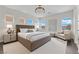 Staged main bedroom with neutral tones, a plush king bed, and views from the large windows at 367 Wilford Springs St, Henderson, NV 89014