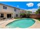 Beautiful backyard with an inviting pool, a lush green lawn, and a covered patio with outdoor seating at 3717 Shanagolden St, Las Vegas, NV 89129