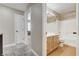 Bathroom showing wood vanity with sink, framed mirror and shower over tub at 3717 Shanagolden St, Las Vegas, NV 89129