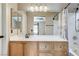 Bathroom featuring a wooden vanity with a large mirror and shower-tub combination at 3717 Shanagolden St, Las Vegas, NV 89129