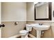 Cozy powder room featuring a pedestal sink, toilet, and decorative mirror at 3717 Shanagolden St, Las Vegas, NV 89129