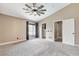 Bright bedroom features neutral tones, soft carpet, ceiling fan, and closet for storage solutions at 3717 Shanagolden St, Las Vegas, NV 89129