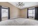 Spacious bedroom with vaulted ceiling, neutral carpet, and ample natural light from dual windows at 3717 Shanagolden St, Las Vegas, NV 89129