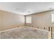 Bright bonus room with carpeted floors, neutral tones, and large windows at 3717 Shanagolden St, Las Vegas, NV 89129