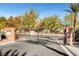 Gated entrance to a community featuring a playground and mature trees at 3717 Shanagolden St, Las Vegas, NV 89129