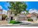 Two-story home showcasing a two-car garage, manicured lawn, and drought resistant landscaping at 3717 Shanagolden St, Las Vegas, NV 89129