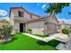 Charming home featuring a two-car garage and well-maintained front yard with a beautiful bush and artificial grass at 3717 Shanagolden St, Las Vegas, NV 89129