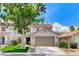 Charming two-story home with a well-manicured lawn, mature tree, and a two-car garage at 3717 Shanagolden St, Las Vegas, NV 89129