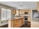 Bright kitchen with large island, light wood cabinets, and stainless steel appliances at 3717 Shanagolden St, Las Vegas, NV 89129