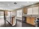 Bright kitchen with an island, light wood cabinets, stainless steel appliances and access to the backyard at 3717 Shanagolden St, Las Vegas, NV 89129