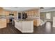 Kitchen features a large island, light wood cabinets, stainless appliances and eat-in space at 3717 Shanagolden St, Las Vegas, NV 89129