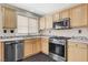 Well-lit kitchen featuring stainless steel appliances, gas range, and ample wooden cabinetry at 3717 Shanagolden St, Las Vegas, NV 89129