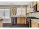 Kitchen with light wood cabinets, black appliances and mosaic tile backsplash at 3717 Shanagolden St, Las Vegas, NV 89129