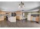 Spacious kitchen features light wood cabinets, gray tile floors, island and stainless steel appliances at 3717 Shanagolden St, Las Vegas, NV 89129