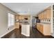 Large kitchen with an island, stainless appliances, light wood cabinets, and eat-in space at 3717 Shanagolden St, Las Vegas, NV 89129