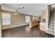 Bright eat-in kitchen features island, light wood cabinets, modern pendant lighting, and staircase to the upper level at 3717 Shanagolden St, Las Vegas, NV 89129
