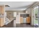 Open floorplan living room with staircase and wet bar and sliding doors to the backyard at 3717 Shanagolden St, Las Vegas, NV 89129