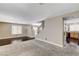 Open-concept living room featuring carpet, wood flooring, and staircase leading to upper level at 3717 Shanagolden St, Las Vegas, NV 89129
