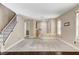 Bright living room featuring carpet, wood flooring, staircase, and an open entry way at 3717 Shanagolden St, Las Vegas, NV 89129