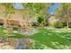 Community park featuring mature trees, a picnic table, seating, lush green grass, and manicured landscaping at 3717 Shanagolden St, Las Vegas, NV 89129