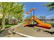 Community playground with slides, benches, and lush green landscaping on a sunny day at 3717 Shanagolden St, Las Vegas, NV 89129