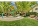 This community playground features colorful equipment, picnic tables, and mature shade trees at 3717 Shanagolden St, Las Vegas, NV 89129