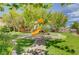 Inviting community playground with a colorful playset, surrounded by lush green grass and mature trees at 3717 Shanagolden St, Las Vegas, NV 89129