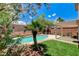 Backyard oasis featuring a beautiful pool, a small palm tree, and a patio with seating at 3717 Shanagolden St, Las Vegas, NV 89129