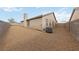Expansive backyard features neutral gravel, perimeter fencing, and an air conditioning unit at 383 Virginia Lake Ave, Henderson, NV 89015