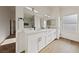 Bathroom featuring double sink vanity, quartz countertops and modern fixtures at 383 Virginia Lake Ave, Henderson, NV 89015