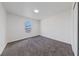 Minimal bedroom with plush gray carpet and a single window providing natural light at 383 Virginia Lake Ave, Henderson, NV 89015