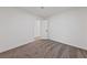 A minimal bedroom shows neutral carpet and a door leading to another room or closet at 383 Virginia Lake Ave, Henderson, NV 89015