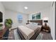 Stylishly staged bedroom with a mounted TV and a window for plenty of natural light at 383 Virginia Lake Ave, Henderson, NV 89015