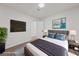 Comfortable bedroom featuring stylish decor, a mounted television, and hardwood floors at 383 Virginia Lake Ave, Henderson, NV 89015