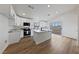 Newly remodeled kitchen with white cabinetry, stainless appliances, island, and sliding door access to backyard at 383 Virginia Lake Ave, Henderson, NV 89015