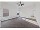 Spacious bedroom with neutral carpet, a ceiling fan, and ensuite access at 383 Virginia Lake Ave, Henderson, NV 89015