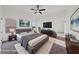 Staged bedroom features neutral decor, tv and an ensuite bathroom at 383 Virginia Lake Ave, Henderson, NV 89015